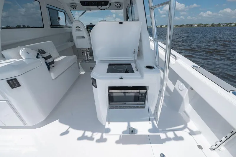 Slide: The Image of Modern Toro 42 yacht interior with kitchenette, seating, and ocean view, 2026 model. - 48