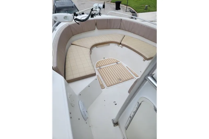 Slide: The Image of 1999 Mako 252 Center Console boat with cushioned seating and deck view. - 16