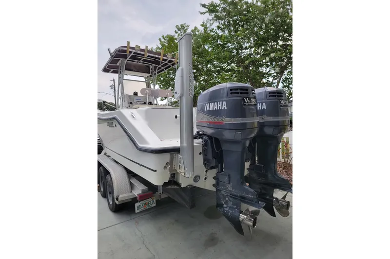 Slide: The Image of 1999 Mako 252 Center Console boat with dual Yamaha V6 engines on trailer. - 31