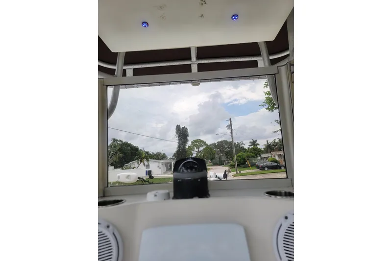 Slide: The Image of Interior view of a 1999 Mako 252 Center Console boat with a clear sky. - 34