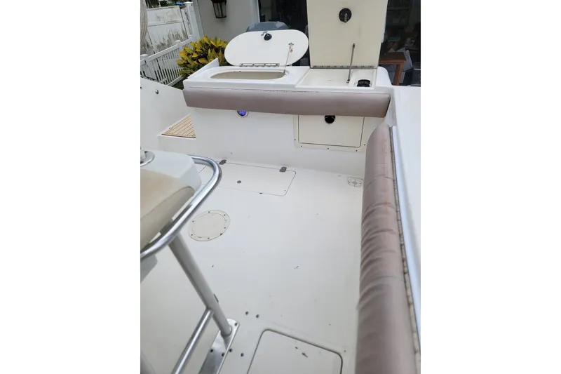 Slide: The Image of 1999 Mako 252 Center Console boat interior with seating and storage compartments. - 23