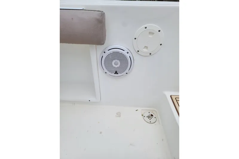 Slide: The Image of Interior view of a 1999 Mako 252 Center Console boat, featuring speaker and hatch. - 32