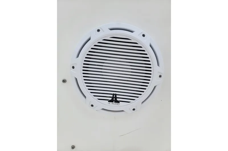 Slide: The Image of White JL Audio marine speaker on a 1999 Mako 252 Center Console boat. - 19