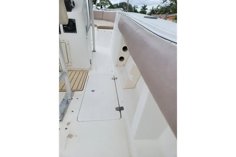 Slide: The Image of 1999 Mako 252 Center Console boat interior with seating and storage compartments. - 15