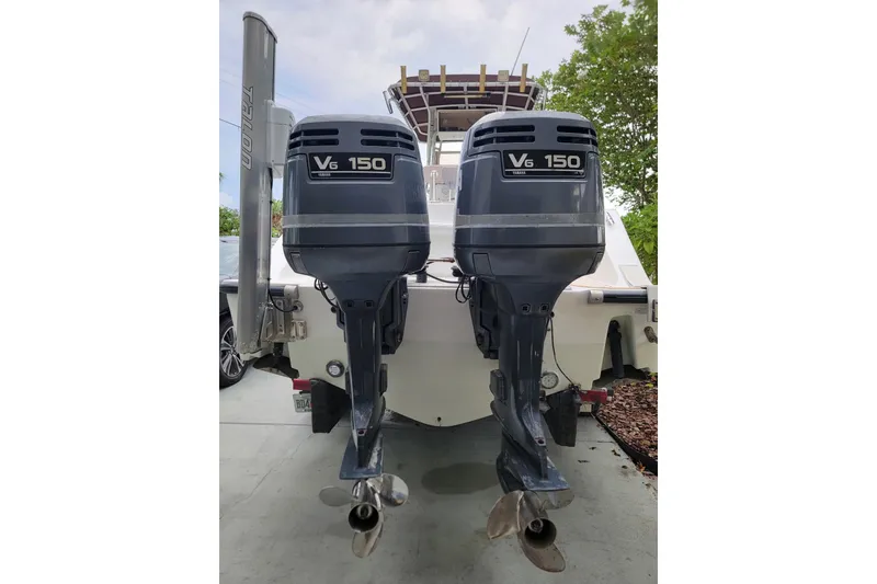 Slide: The Image of 1999 Mako 252 Center Console with twin V6 150 outboard engines. - 30