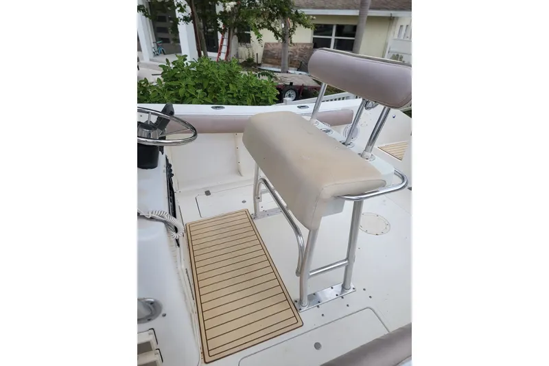 Slide: The Image of 1999 Mako 252 Center Console boat interior with seating and steering wheel. - 24