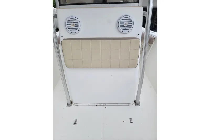 Slide: The Image of 1999 Mako 252 Center Console boat interior with speakers and cushioned panel. - 21