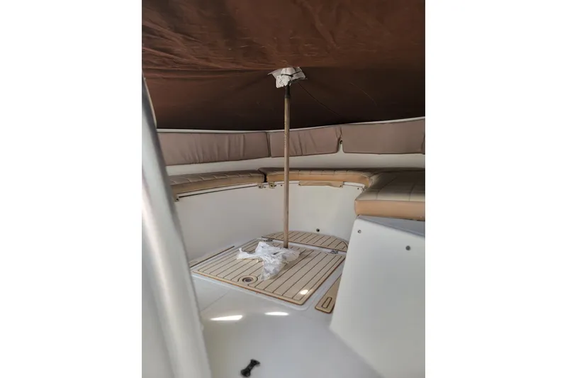 Slide: The Image of Interior view of a 1999 Mako 252 Center Console boat with cushioned seating. - 35