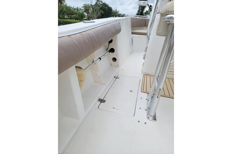 Slide: The Image of 1999 Mako 252 Center Console boat interior with seating and storage compartments. - 14