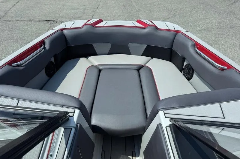 Slide: The Image of 2020 Moomba Max boat interior with gray and red seating, showcasing spacious design. - 11