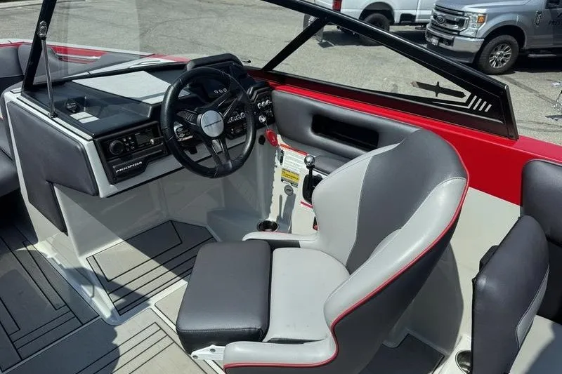 Slide: The Image of 2020 Moomba Max boat interior with steering wheel and seating, featuring modern design elements. - 9