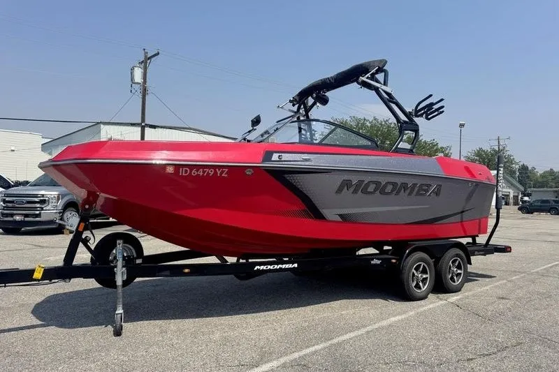 Slide: The Image of 2020 Moomba Max boat in vibrant red on a trailer, parked in a lot. - 6