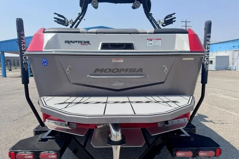 Slide: The Image of 2020 Moomba Max boat rear view with Raptor engine, parked outdoors. - 14