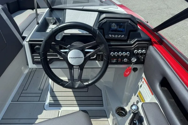 Slide: The Image of 2020 Moomba Max boat dashboard with steering wheel and control panel. - 15