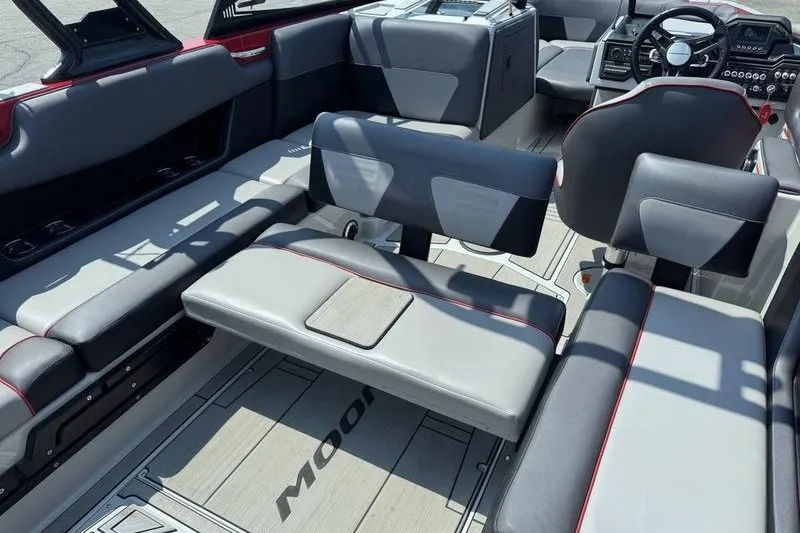 Slide: The Image of Interior of a 2020 Moomba Max boat with gray seating and modern dashboard. - 10