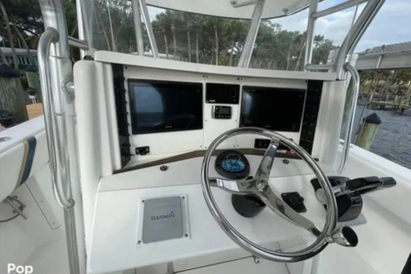 Slide: The Image of 2004 Venture 34 Cuddy boat helm with Garmin navigation system and dual displays. - 4