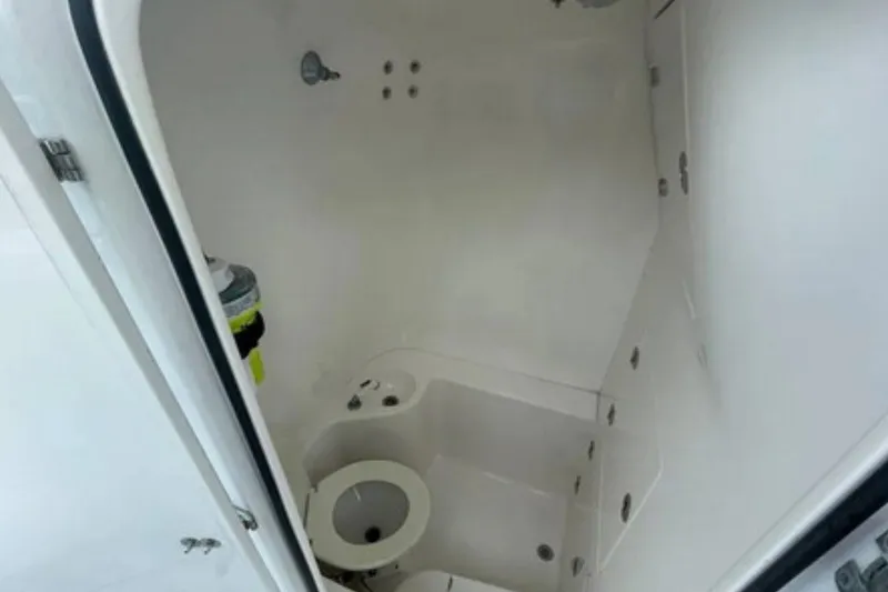 Slide: The Image of Interior view of 2004 Venture 34 Cuddy boat bathroom with compact design. - 15