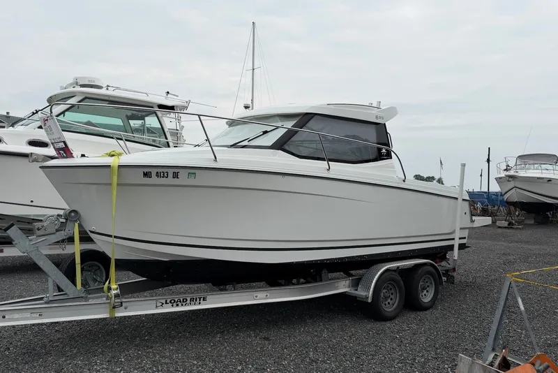 The Image of 2017 Jeanneau Merry Fisher 695 boat on trailer, parked in a marina. - 0