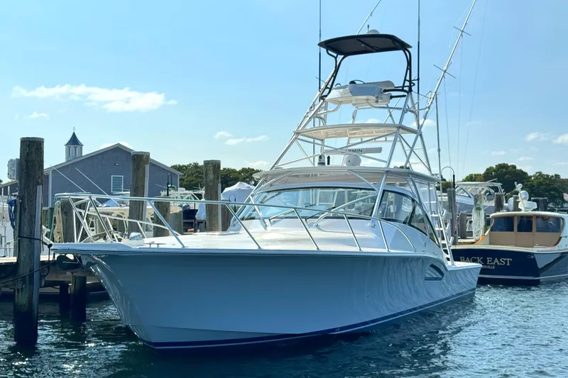 Slide: The Image of Albemarle 41 Custom Carolina Edition 2023 docked, featuring a distinctive tower and clear blue water setting. - 5