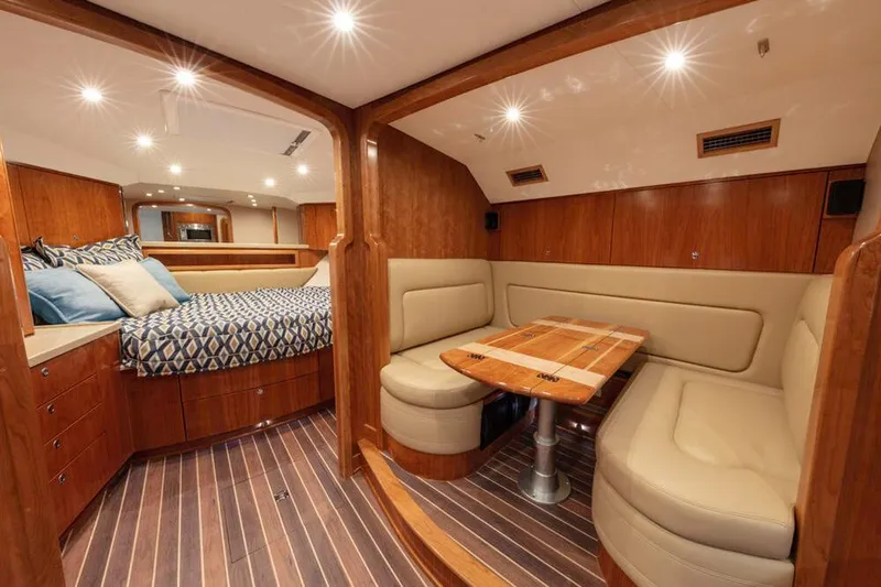 Slide: The Image of Interior of the 2023 Albemarle 41 Custom Carolina Edition with wood floors and cozy seating areas. - 18