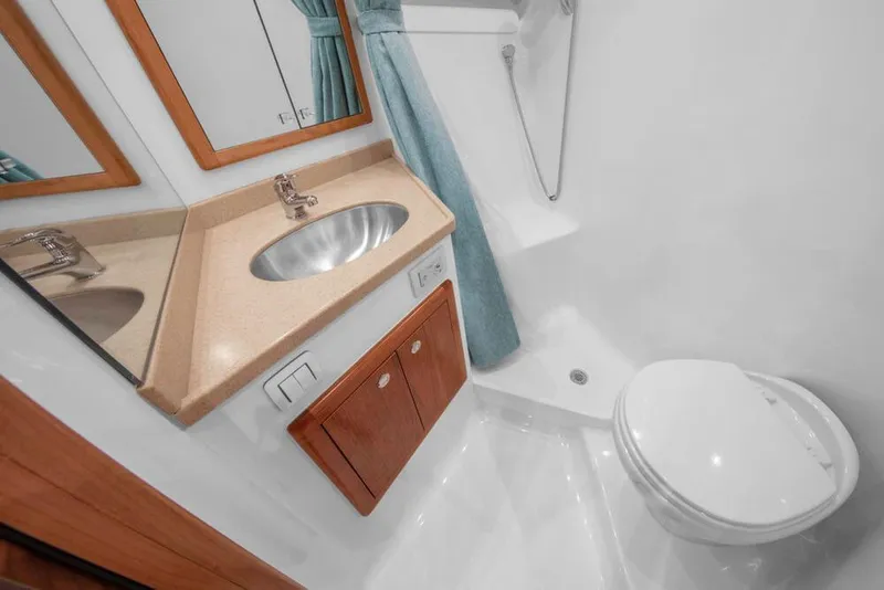 Slide: The Image of The image shows a modern boat bathroom with a sink, toilet, and shower. - 21