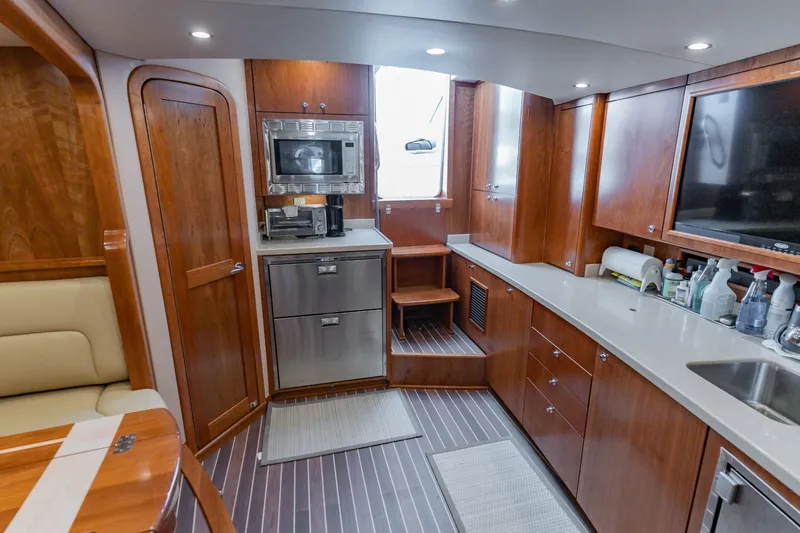 Slide: The Image of Luxurious interior of 2023 Albemarle 41 Custom Carolina Edition yacht with modern kitchen amenities. - 18