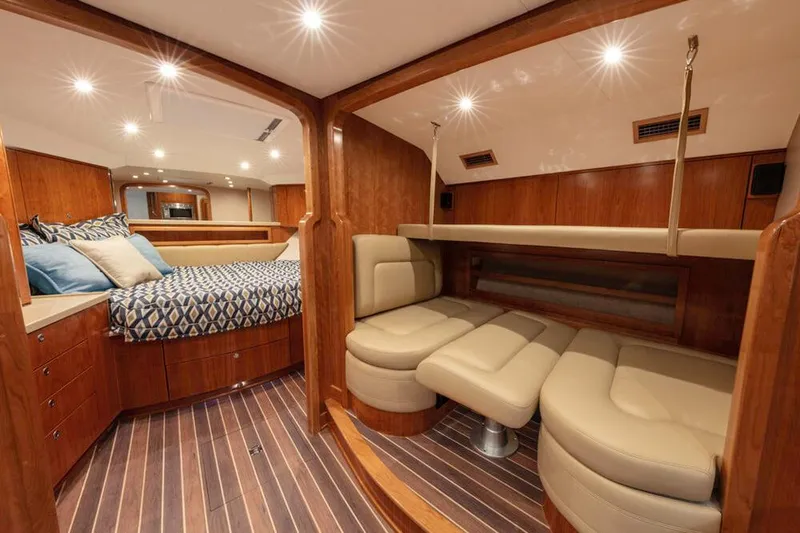 Slide: The Image of The cabin of the 2023 Albemarle 41 Custom Carolina Edition features a luxurious interior with wood accents and comfortable seating. - 19