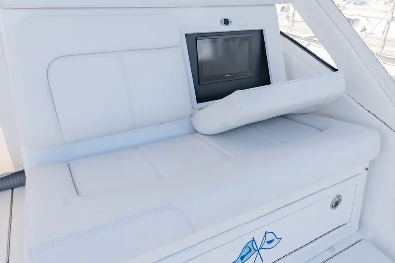 Slide: The Image of 2023 Albemarle 41 Custom Carolina Edition interior with white seating and built-in screen. - 14