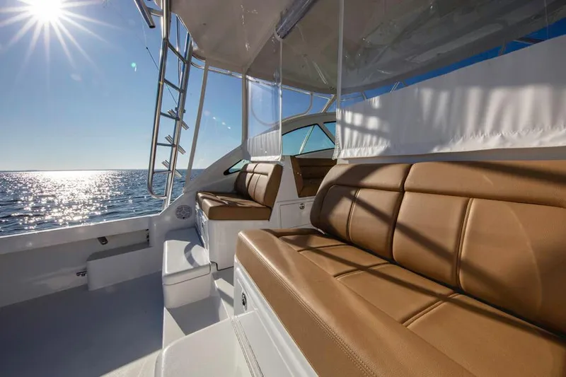 Slide: The Image of The image shows the deck of a 2023 Albemarle 41 Custom Carolina Edition with brown leather seats. - 9