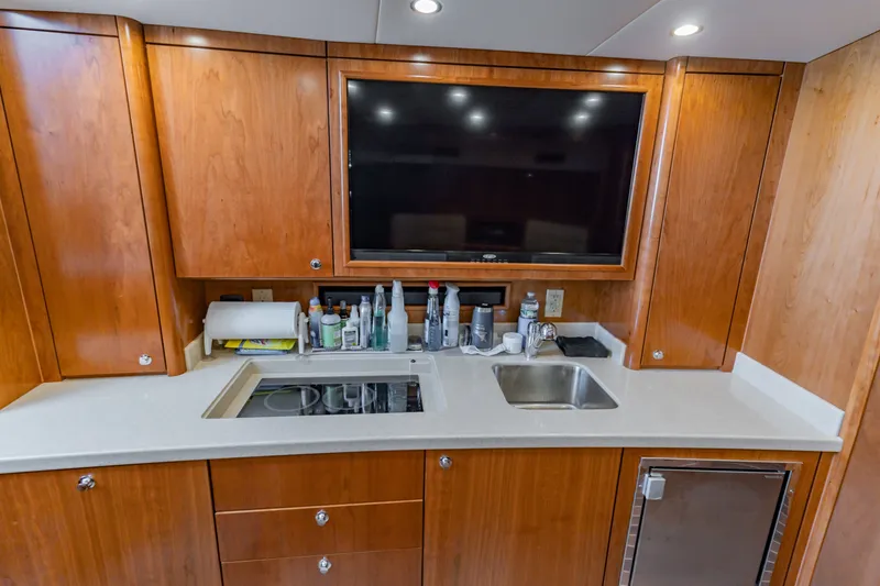 Slide: The Image of Luxurious galley in 2023 Albemarle 41 Custom Carolina Edition yacht with wood cabinetry. - 21