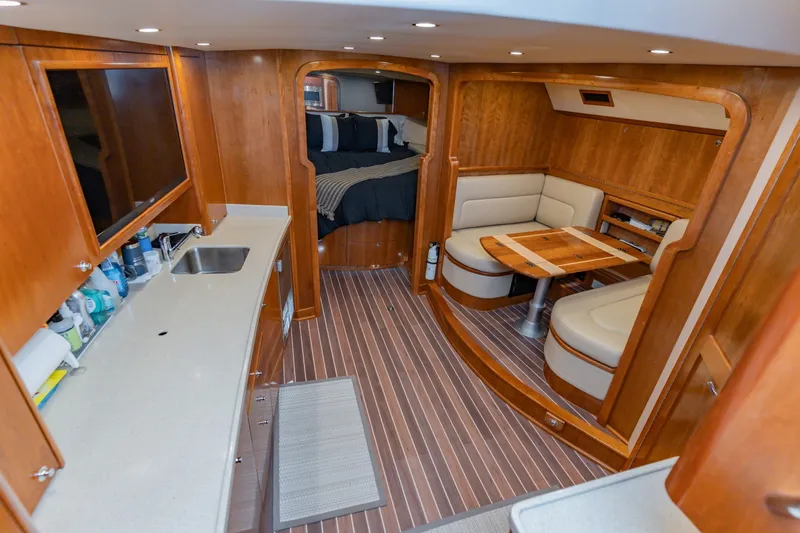 Slide: The Image of Luxurious interior of 2023 Albemarle 41 Custom Carolina Edition yacht with wood finishes and cozy seating. - 23