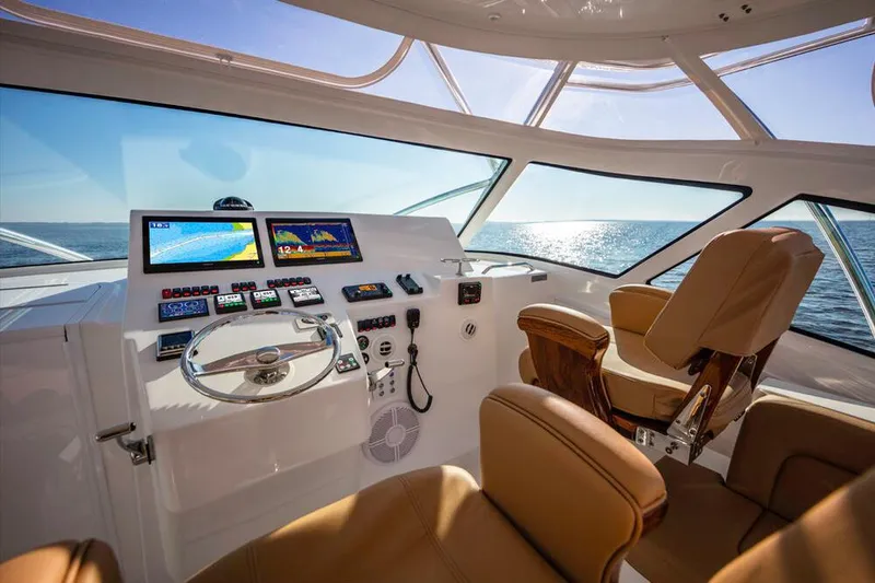Slide: The Image of Interior view of an Albemarle 41 Custom Carolina Edition helm with modern instruments and leather seats. - 12