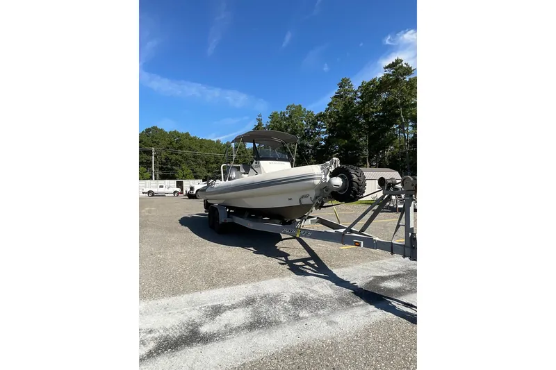 Slide: The Image of 2024 Sealegs 7.5M amphibious boat on trailer under clear blue sky. - 10