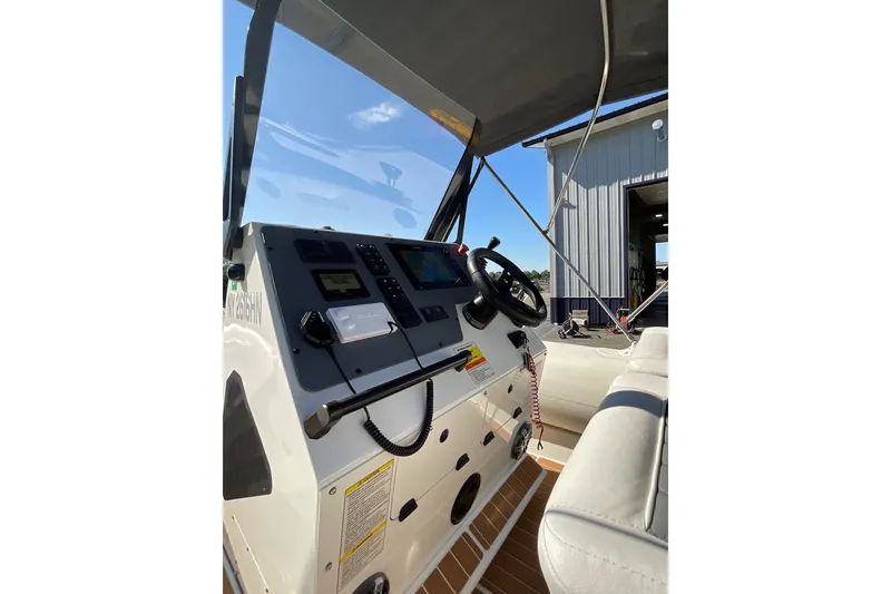 Slide: The Image of 2024 Sealegs 7.5M boat cockpit with steering wheel and control panel. - 26