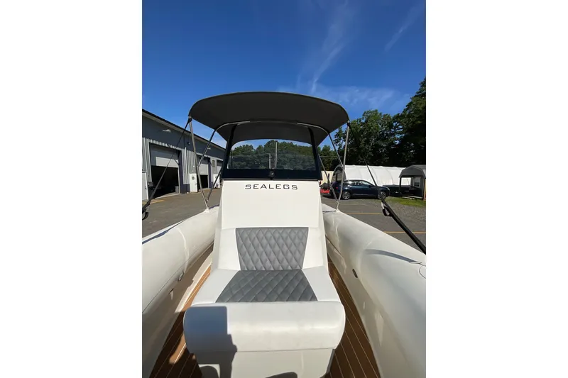 Slide: The Image of 2024 Sealegs 7.5M boat with canopy, parked outdoors under clear blue sky. - 15
