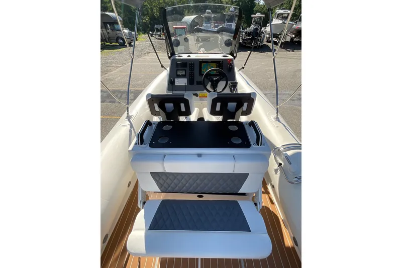 Slide: The Image of 2024 Sealegs 7.5M boat interior with dual seats and modern dashboard controls. - 25