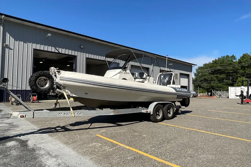 Slide: The Image of 2024 Sealegs 7.5M amphibious boat on trailer outside a warehouse. - 5