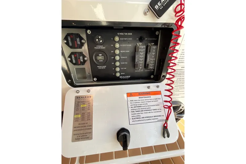 Slide: The Image of Control panel of 2024 Sealegs 7.5M boat with warning labels and switches. - 27