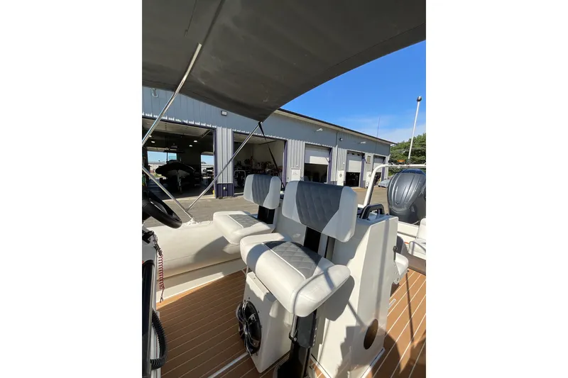 Slide: The Image of 2024 Sealegs 7.5M boat interior with cushioned seating and steering wheel. - 31