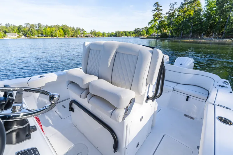 Slide: The Image of Luxurious seating on 2027 Sea Hunt Ultra 265SE boat, with scenic lake view. - 17