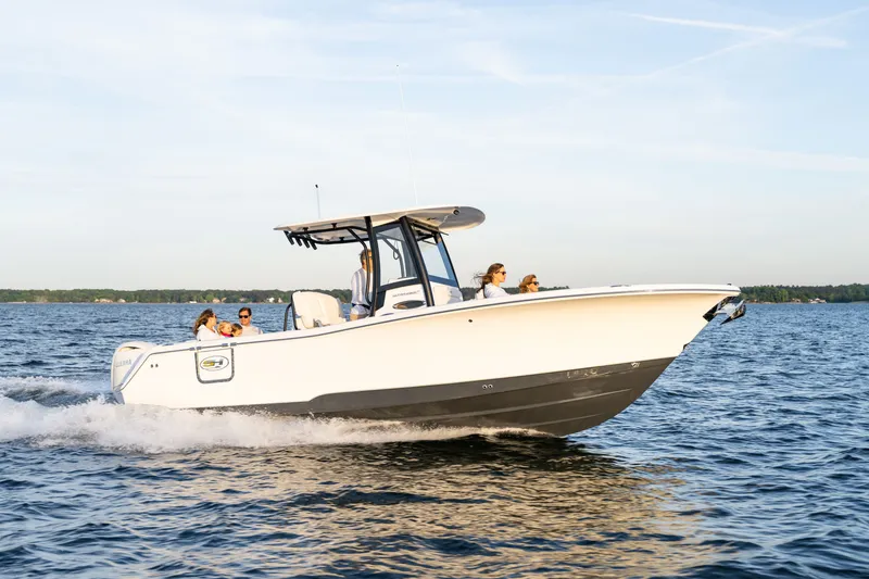 Slide: The Image of 2027 Sea Hunt Ultra 265SE boat cruising on a sunny day with passengers onboard. - 44