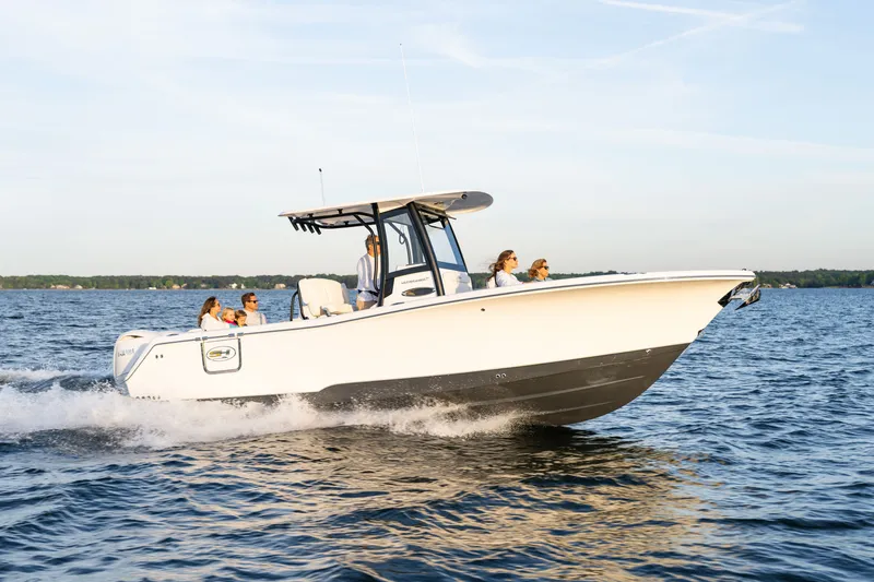 Slide: The Image of 2027 Sea Hunt Ultra 265SE boat cruising on a sunny day with passengers onboard. - 43