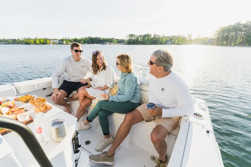 Slide: The Image of Group enjoying a sunny day on a 2027 Sea Hunt Ultra 265SE boat. - 37