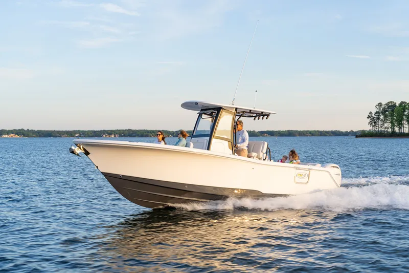 Slide: The Image of 2027 Sea Hunt Ultra 265SE boat cruising on a serene lake. - 48