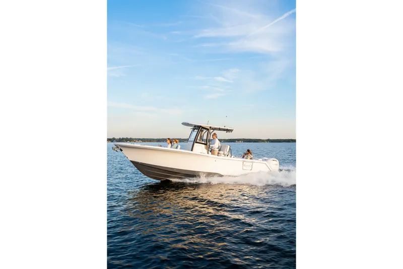 Slide: The Image of 2027 Sea Hunt Ultra 265SE boat cruising on a sunny day with passengers onboard. - 50