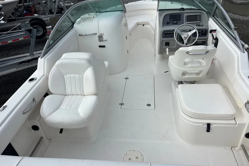 Slide: The Image of 2011 Robalo R227 Dual Console boat interior with white seating and steering console. - 13