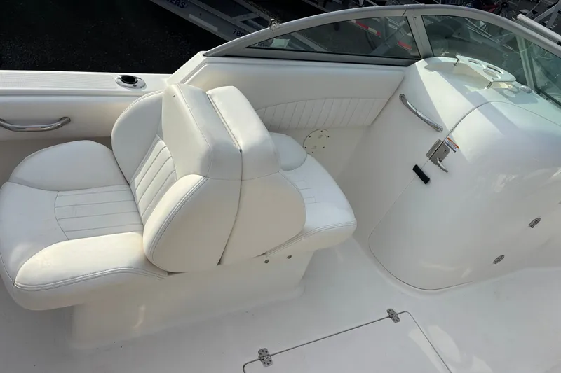 Slide: The Image of 2011 Robalo R227 Dual Console boat interior with white seating and sleek design. - 14