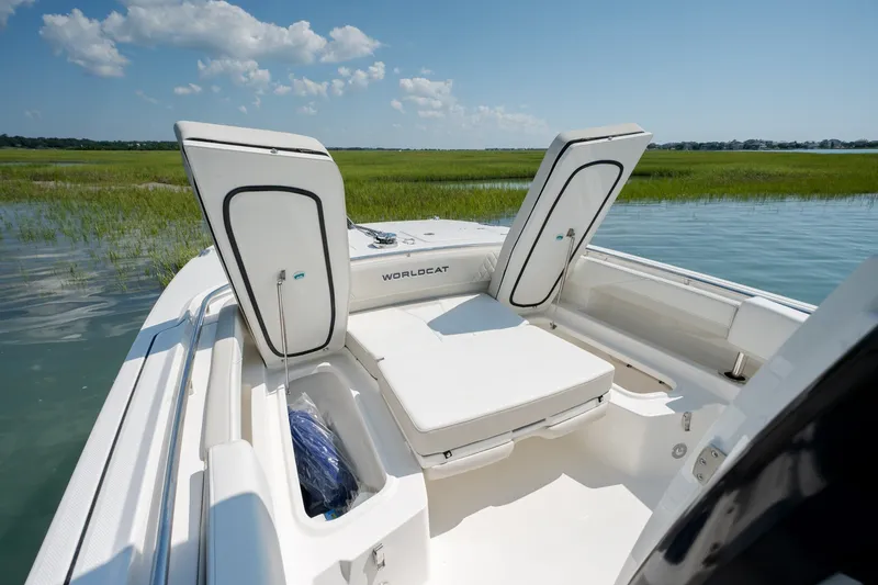 Slide: The Image of 2026 World Cat 265 CC-X boat with open storage compartments on a sunny day. - 16