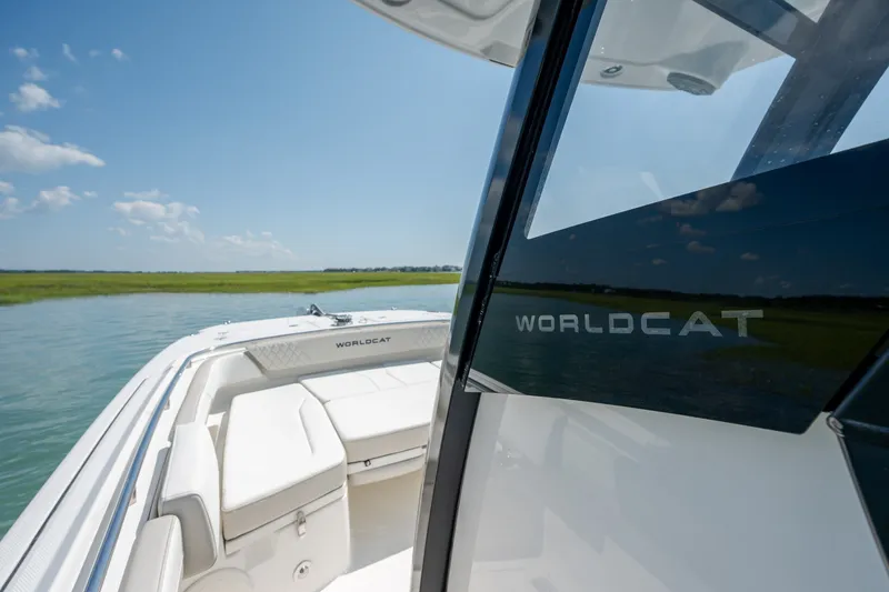 Slide: The Image of 2026 World Cat 265 CC-X boat interior with sleek design on calm water. - 19