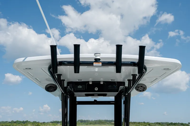 Slide: The Image of 2026 World Cat 265 CC-X boat roof with rod holders against blue sky. - 29